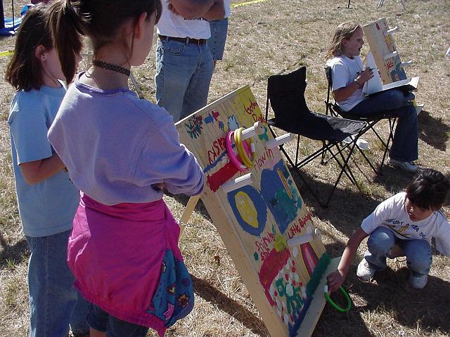 Christine and Amelia watching ring toss.JPG